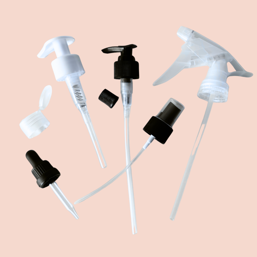 Collection of various bottle nozzles on a beige background